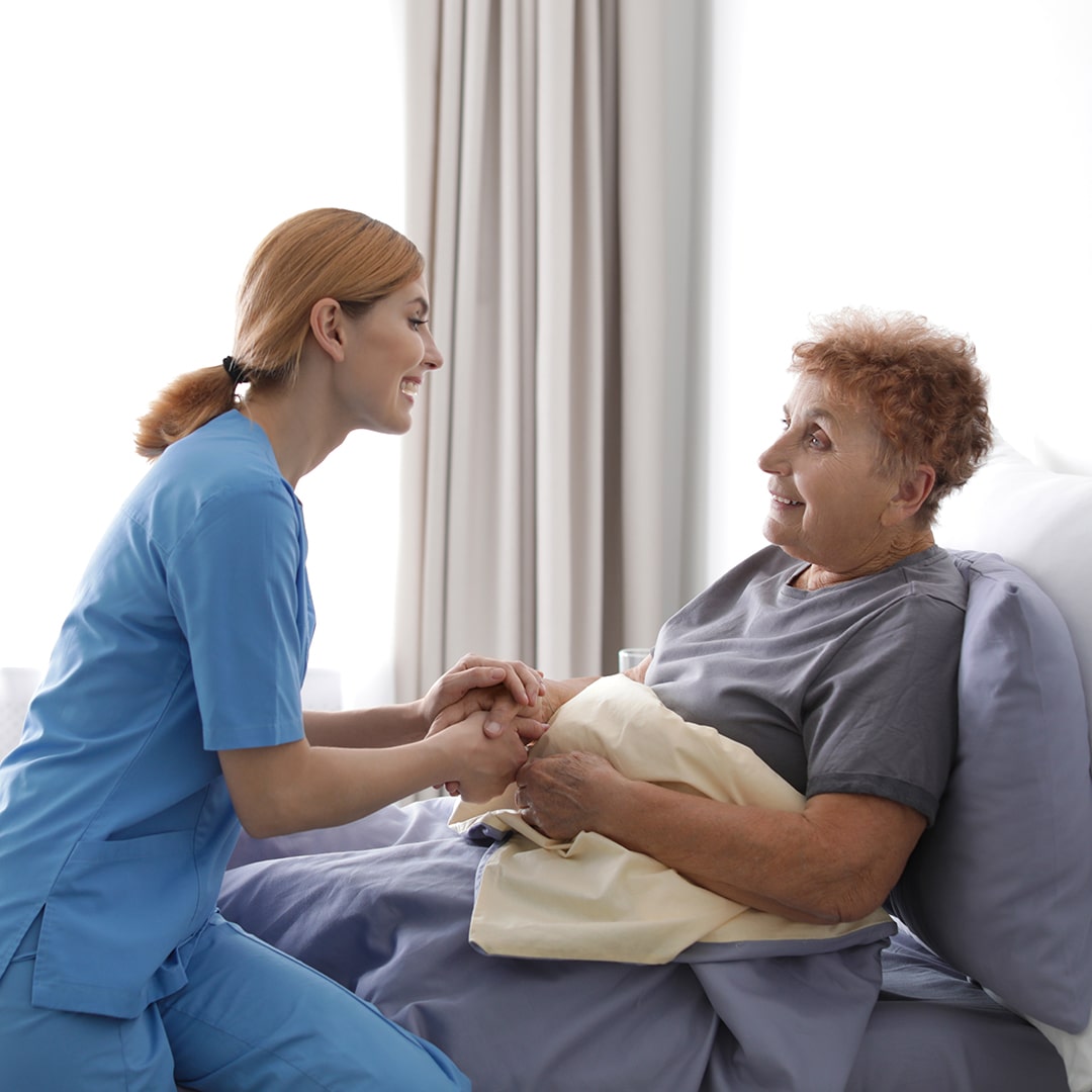 Nurse holding hands with a senior patient
