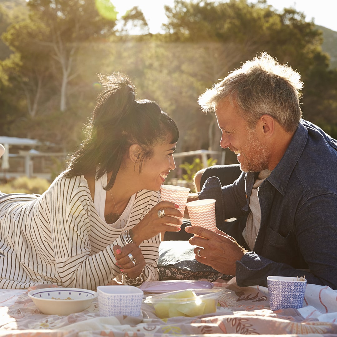 Couple smiling and having a picnic